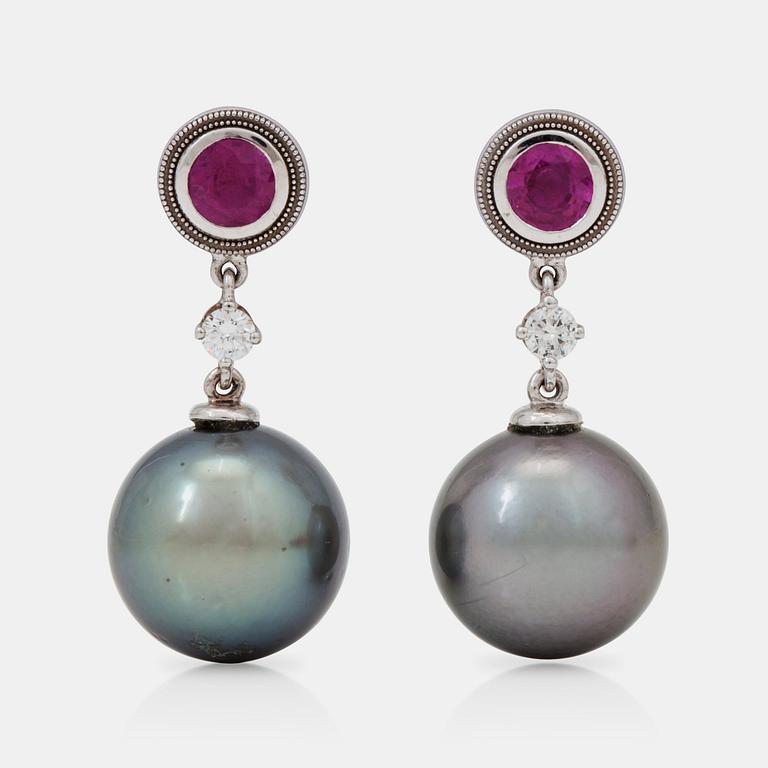 A pair of cultured tahiti pearl, ruby and brilliant-cut diamond earrings.