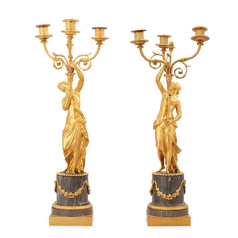 A pair of Louis XVI circa 1780 three-light gilt bronze and bleu turquin marble candelabra.