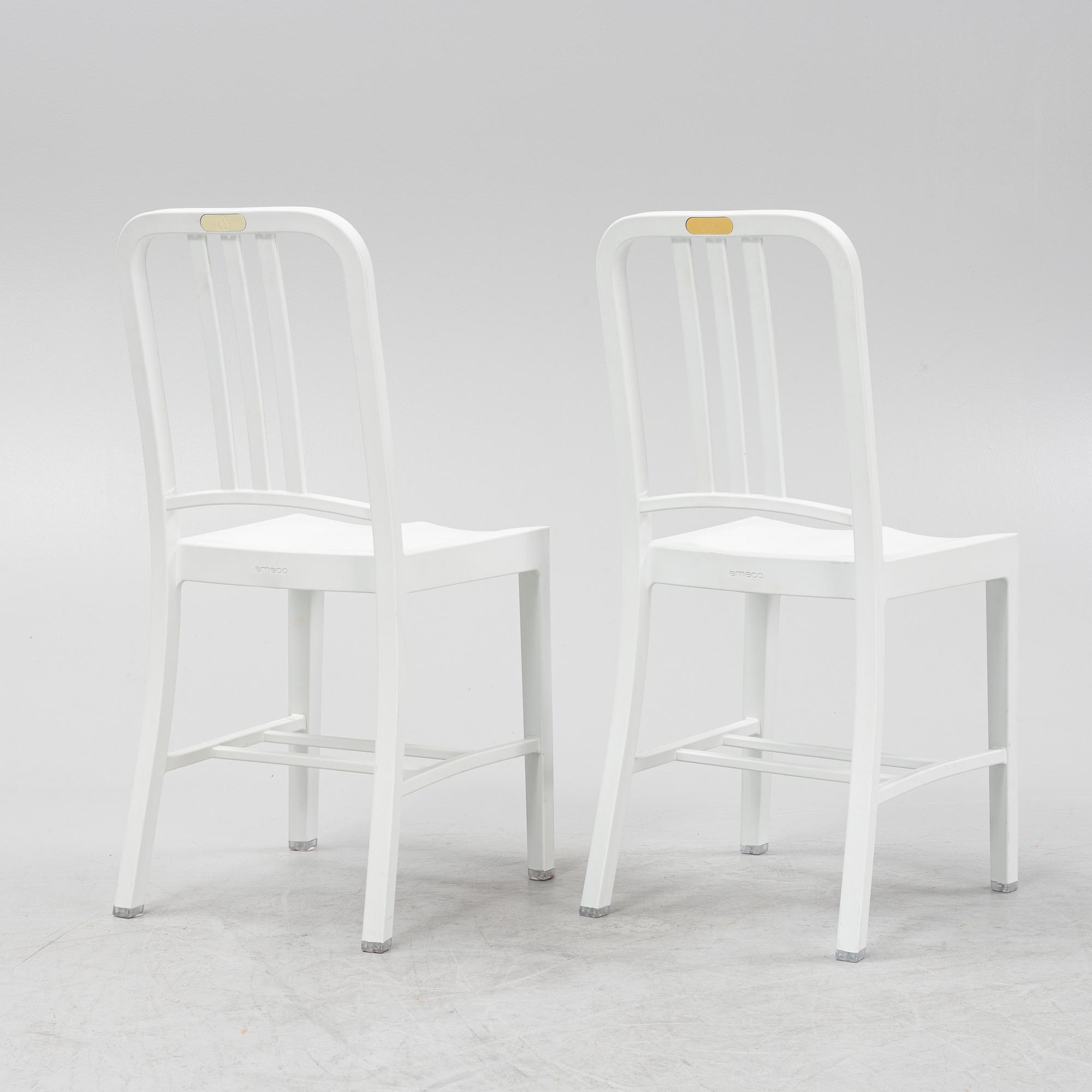 A pair of plastic 'Navy Chair' by Emeco.