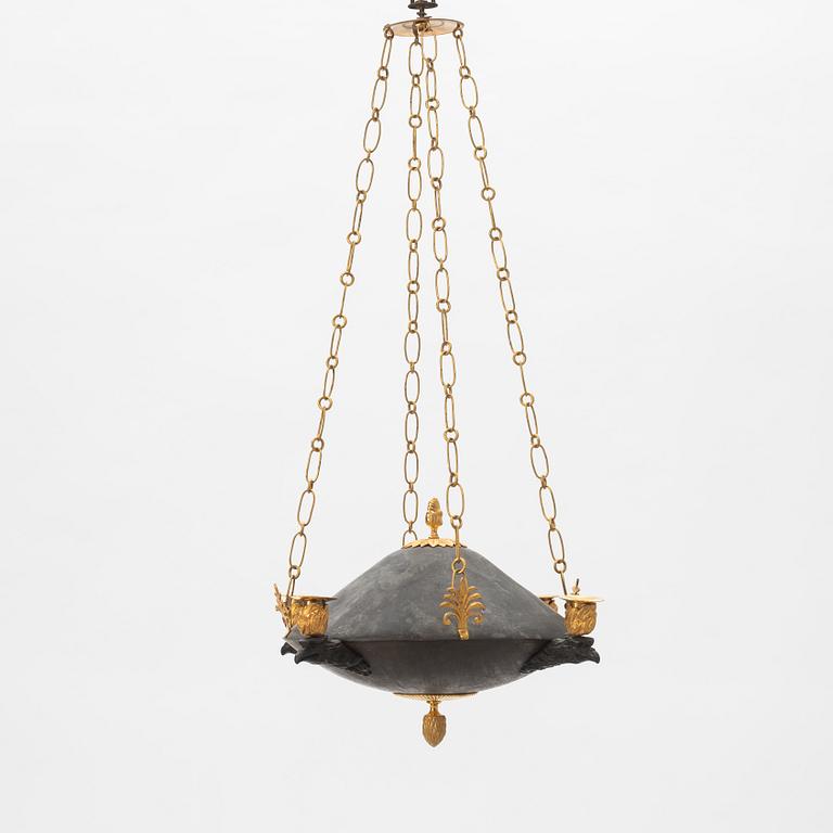 A Swedish Empire ormolu, patinated bronze four-light chandelier, early 19th century.