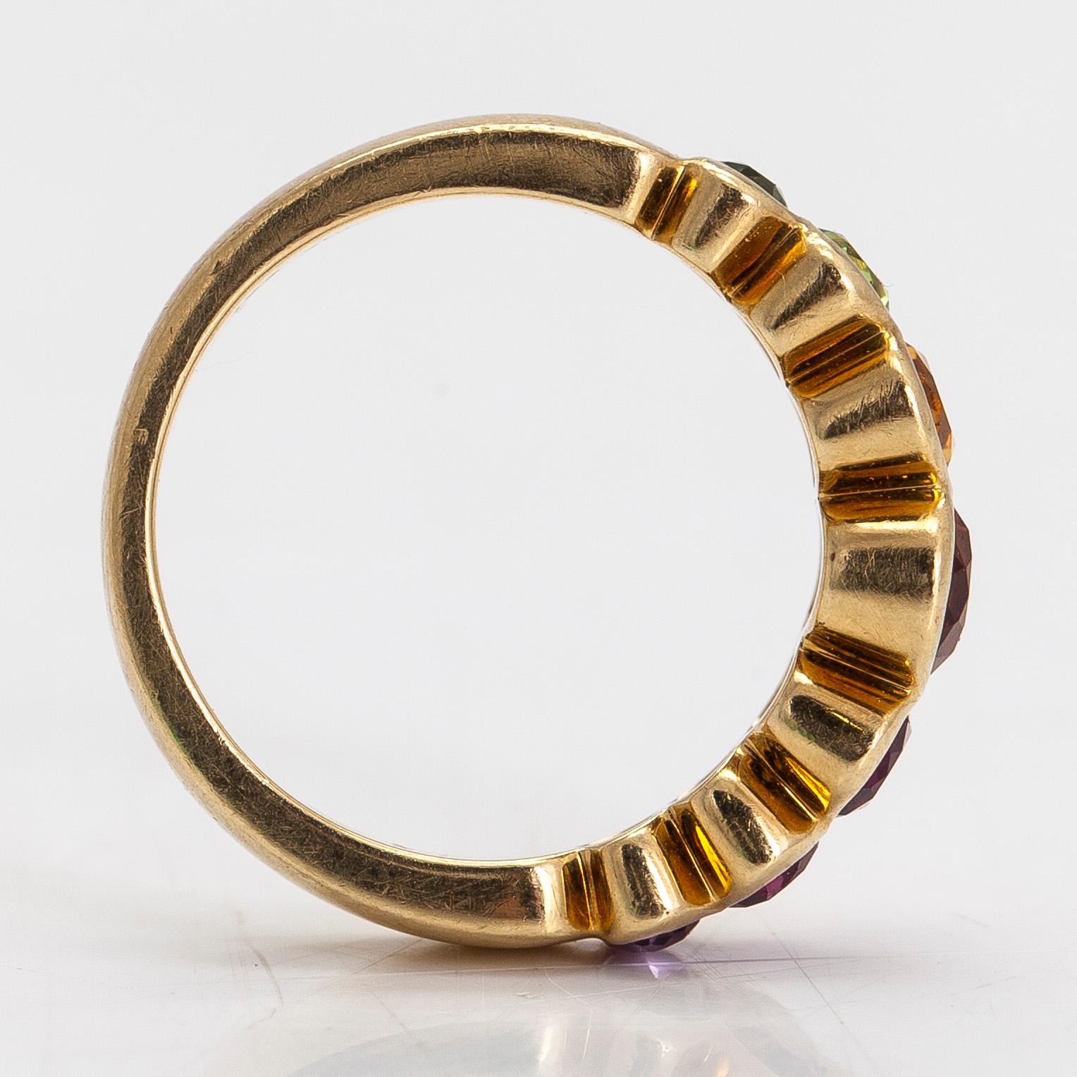 An 18K gold ring, with multi-coloured stones.