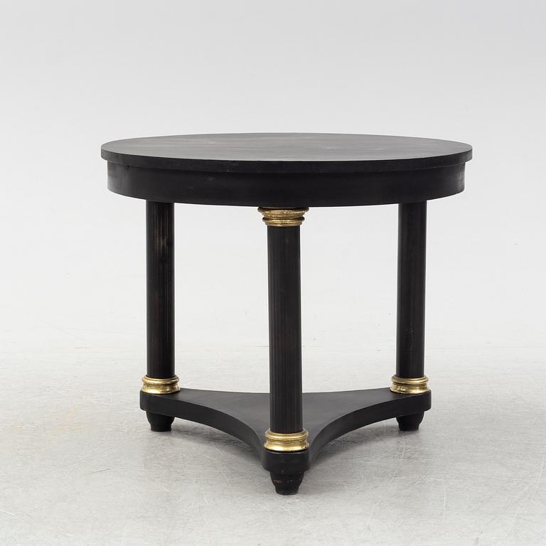 A contemporary empire style sheet metal center table.