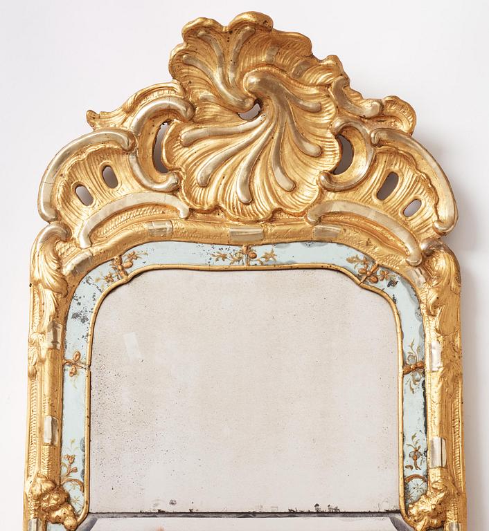 A Swedish rococo giltwood mirror in the manner of E. Göbel, Stockholm, later part 18th century.