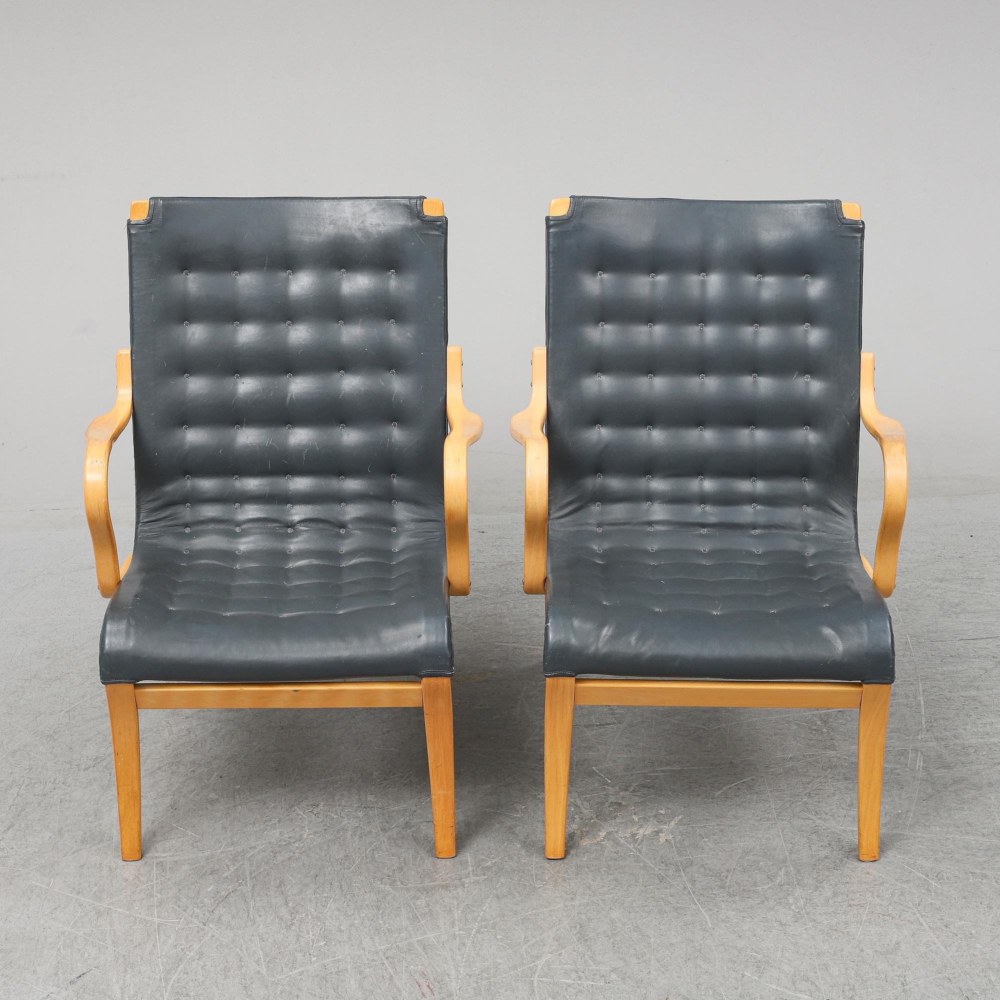 A second half of the 20th Century pair of 'Mina' armchairis by Bruno Mathsson for Mathsson International.