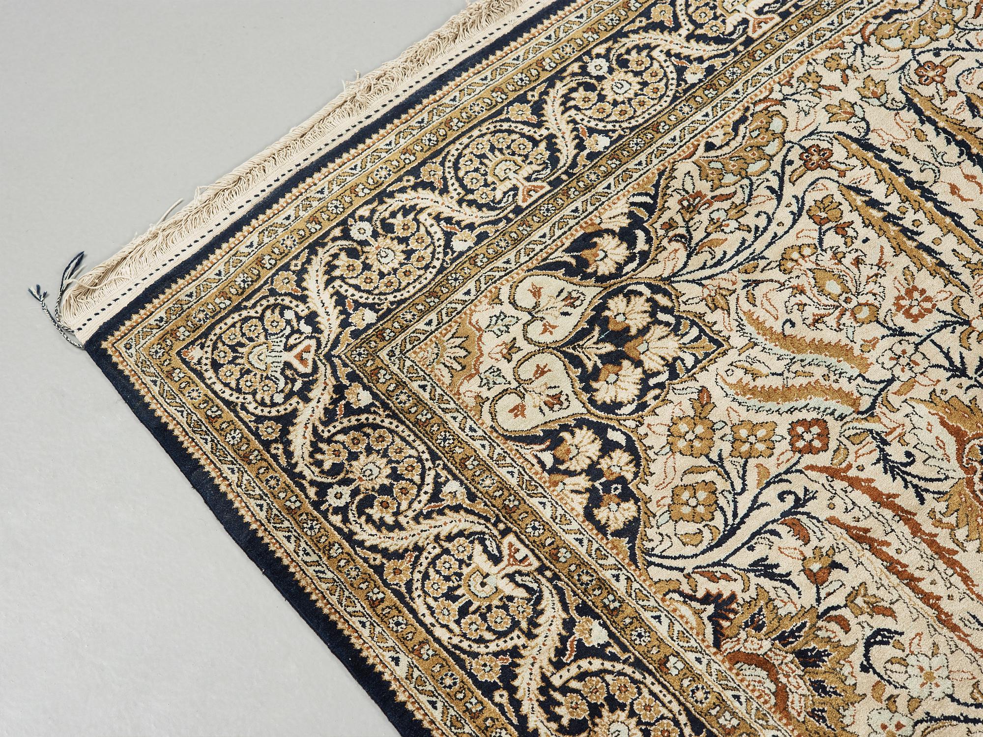 A silk Qum carpet, around  219 x 137 cm.
