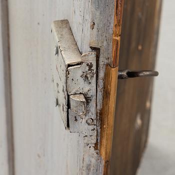 A painted folk art corner hanging cabinet, ca 1800.