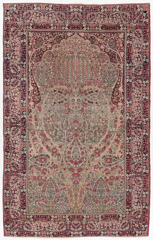 An antique Kirman rug, south Persia, c. 220 x 140 cm.