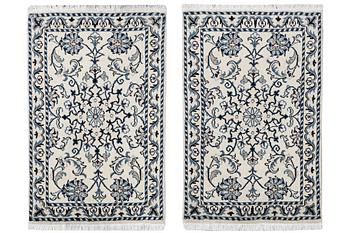 A pair of Nain rugs, part silk, c. 88 x 57 cm & c. 89 x 57 cm.