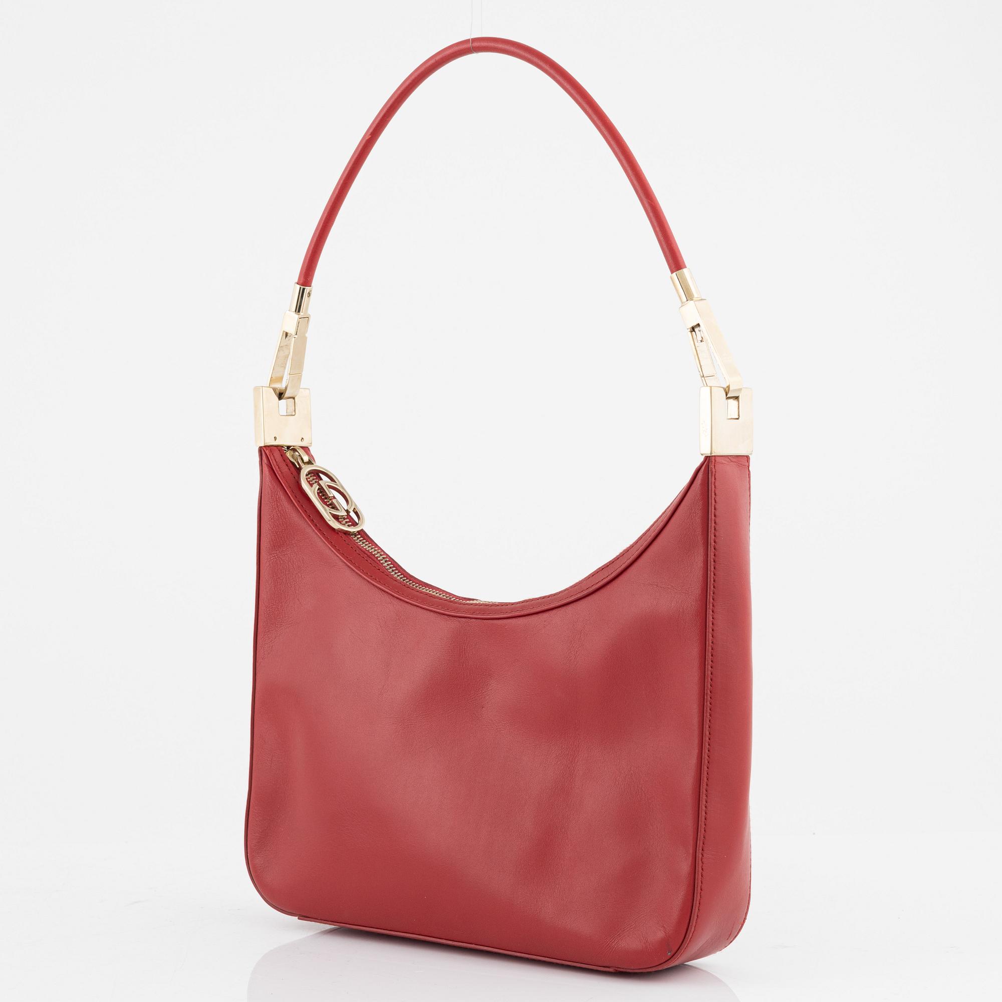 Gucci, a red leather handbag.