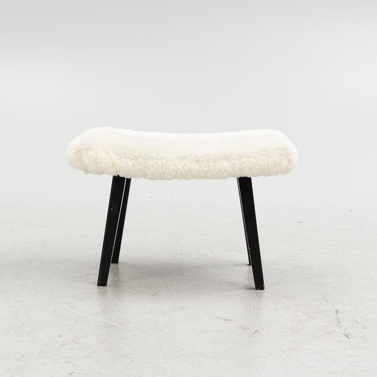 A mid 20th Century stool with sheepskin upholstery.