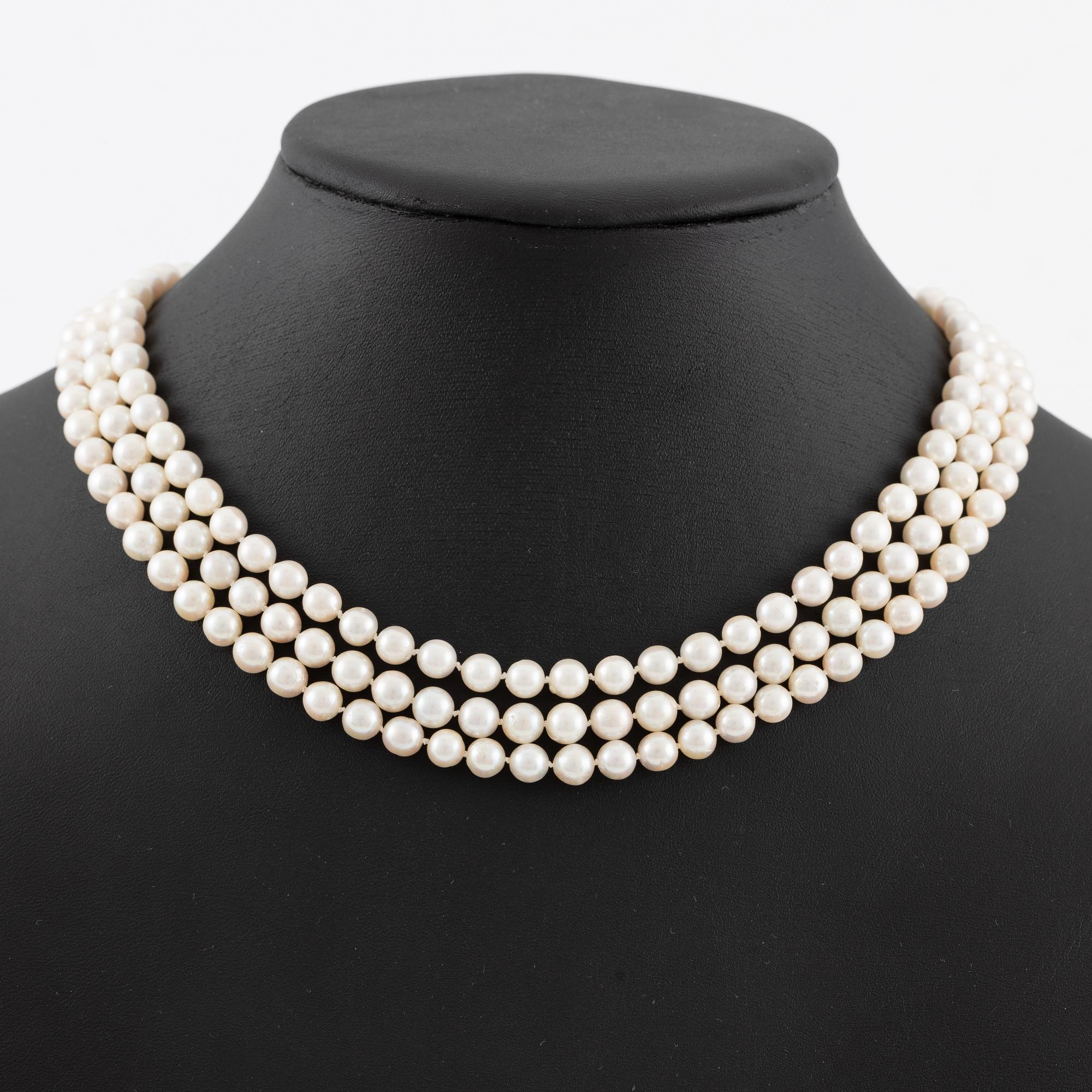 Pearl necklace, three strands of cultured pearls, clasp in 18K gold set with baguette and brilliant-cut diamonds.