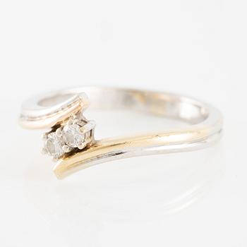 Ring in 14K gold and white gold set with two brilliant-cut diamonds.