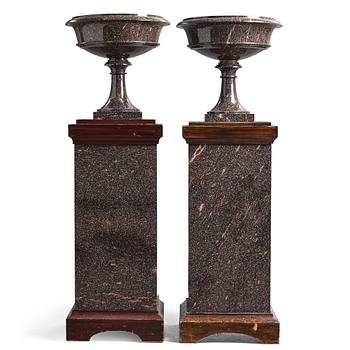 16. A pair of Swedish porpyry vases on wooden bases, Älvdalen, first half of the 19th century.