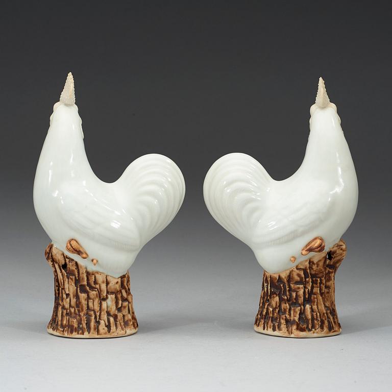 A pair of white and brown glazed figures of roosters, late Qing dynasty,