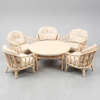 Five rattan easy chairs and a table. 1980's.