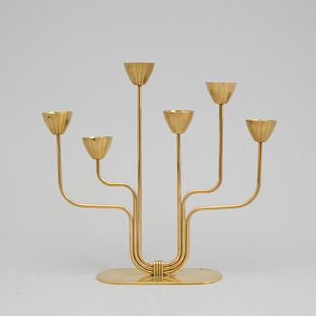 A brass candelabrum and two candlesticks by Ystad Metall, Gunnar Ander.