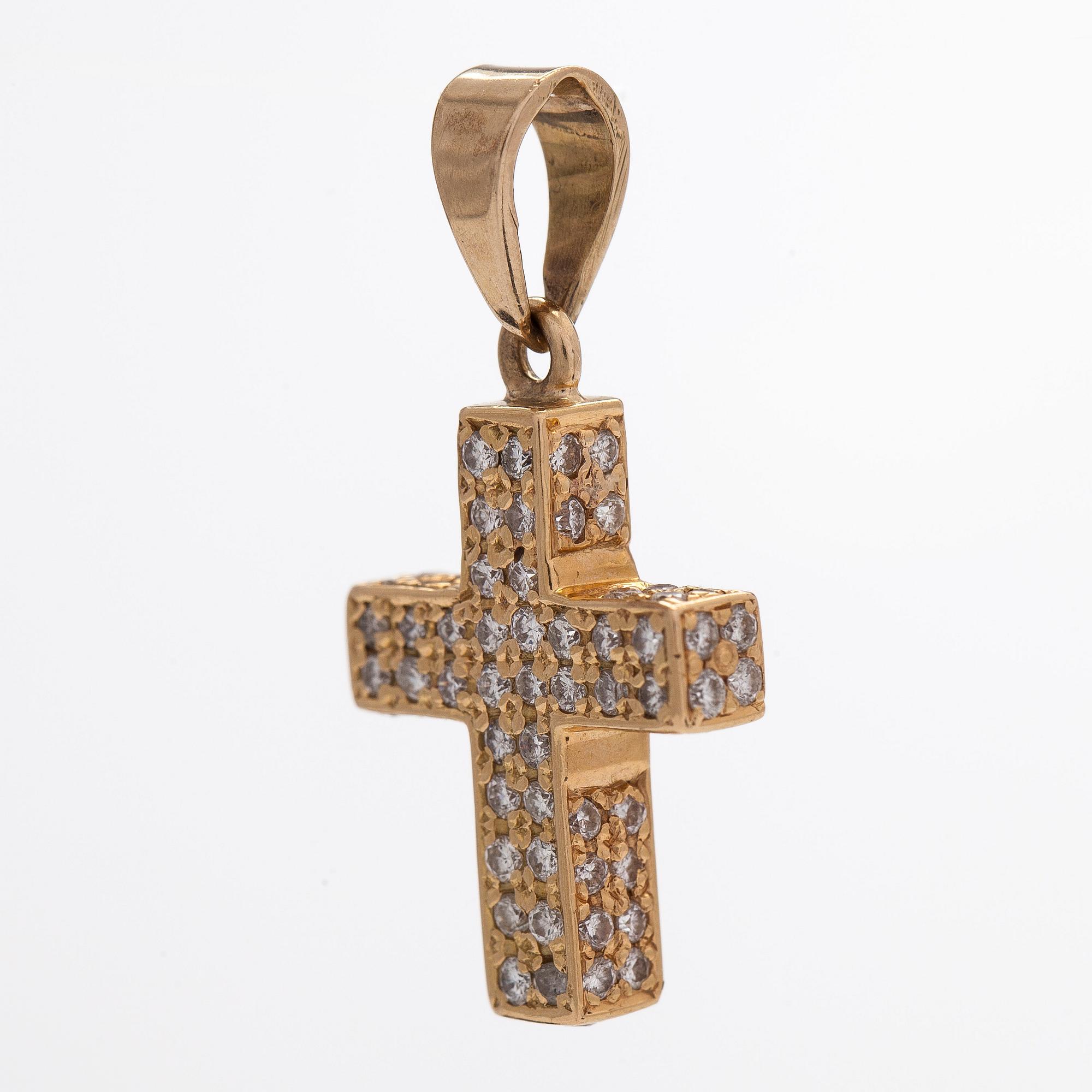 A 14K gold cross pendant with diamonds.