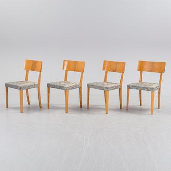 A 1940's dining table an four chairs.