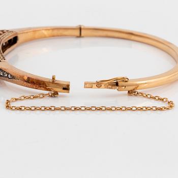 An 18K gold and silver bangle set with rose-cut diamonds.