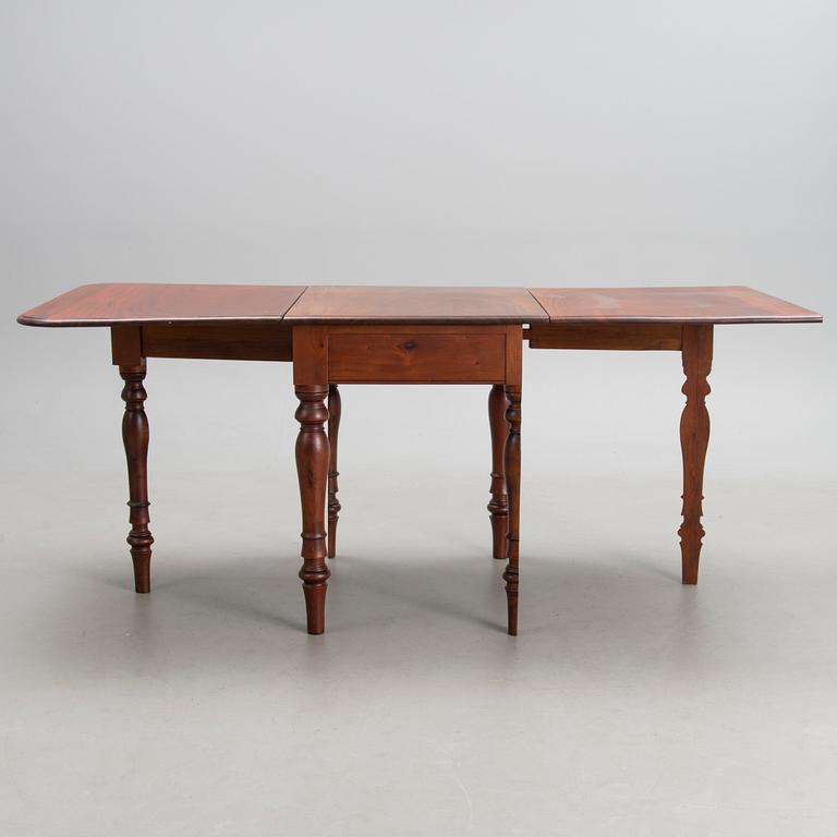 A 19th-20th Century drop leaf table.