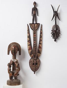 A sculptue and two masks reportedly from The Ivory coast, from the second half of the 20:th century.