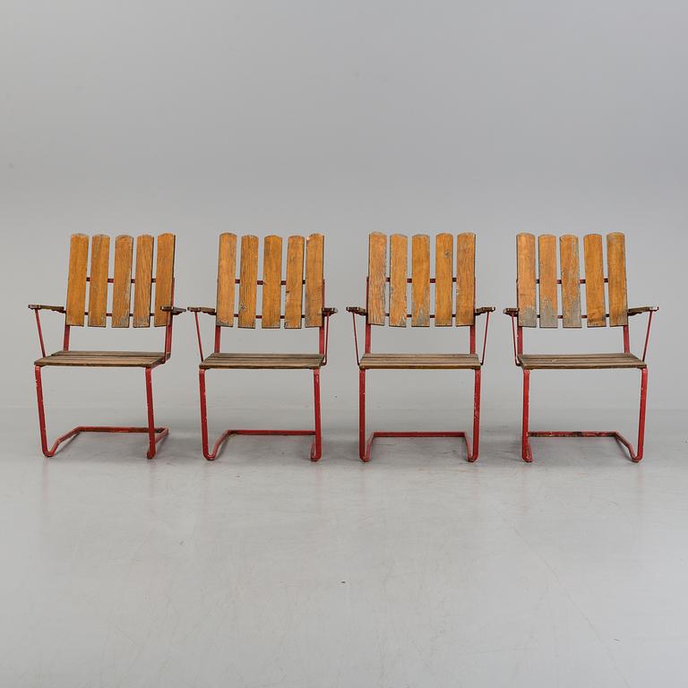 A garden table and four chairs, 20th century.