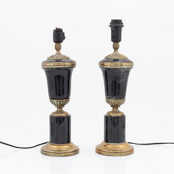 A pair of stone and brass table lamps, 20th century.