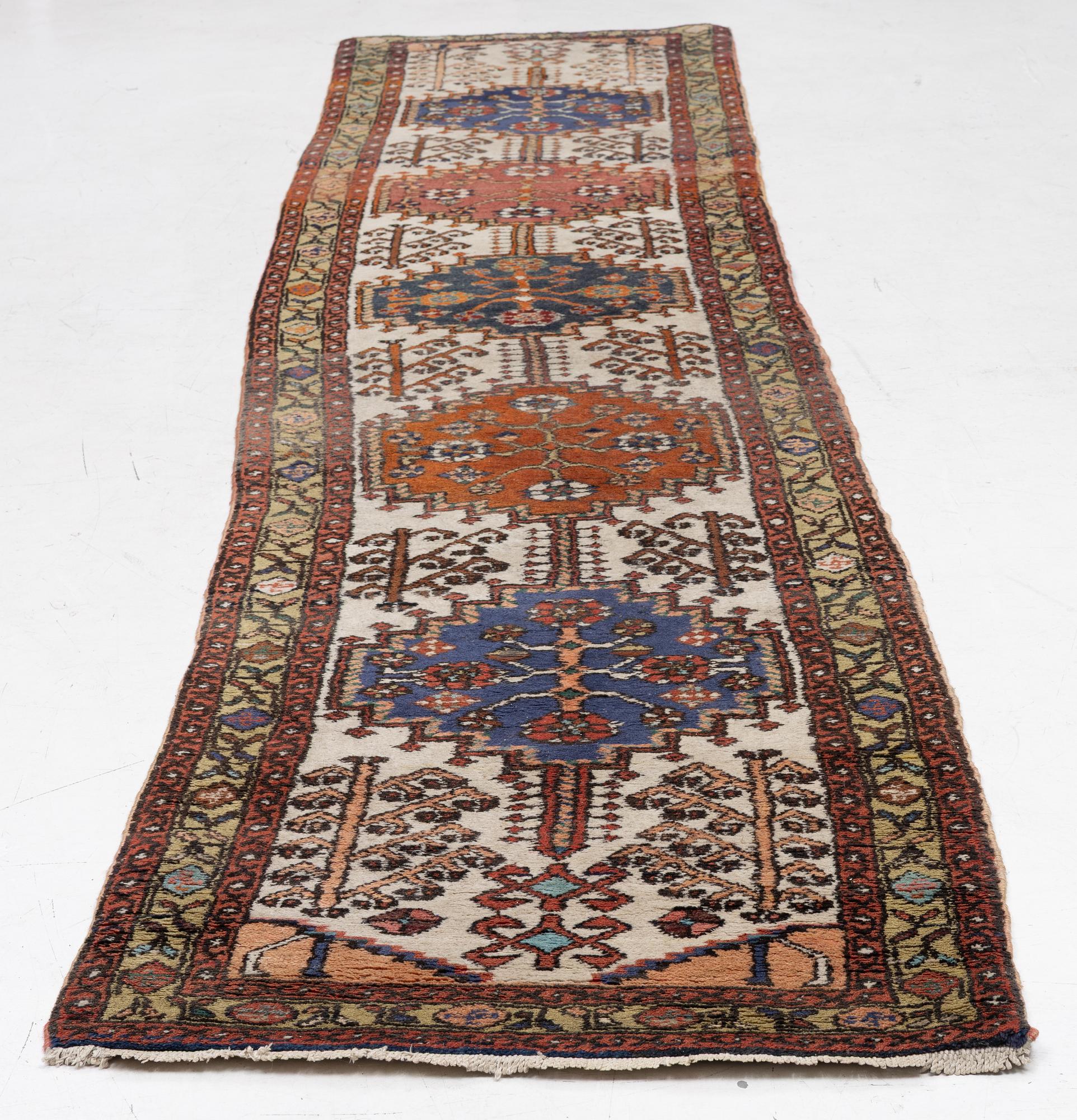 An oriental runner, c. 395 x 82 cm.