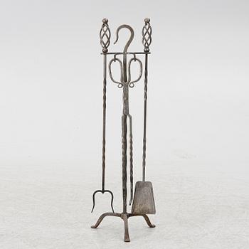 A set of three iron fire utensils with stand, 20th century.