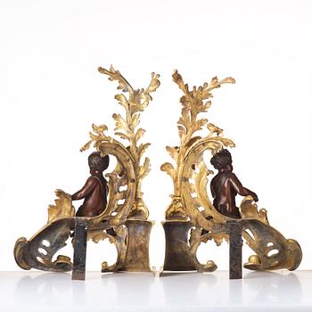 A pair of Louis XV-style 19th century fire dogs.