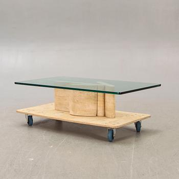 A glass and travertine coffee table later part of the 20th century.