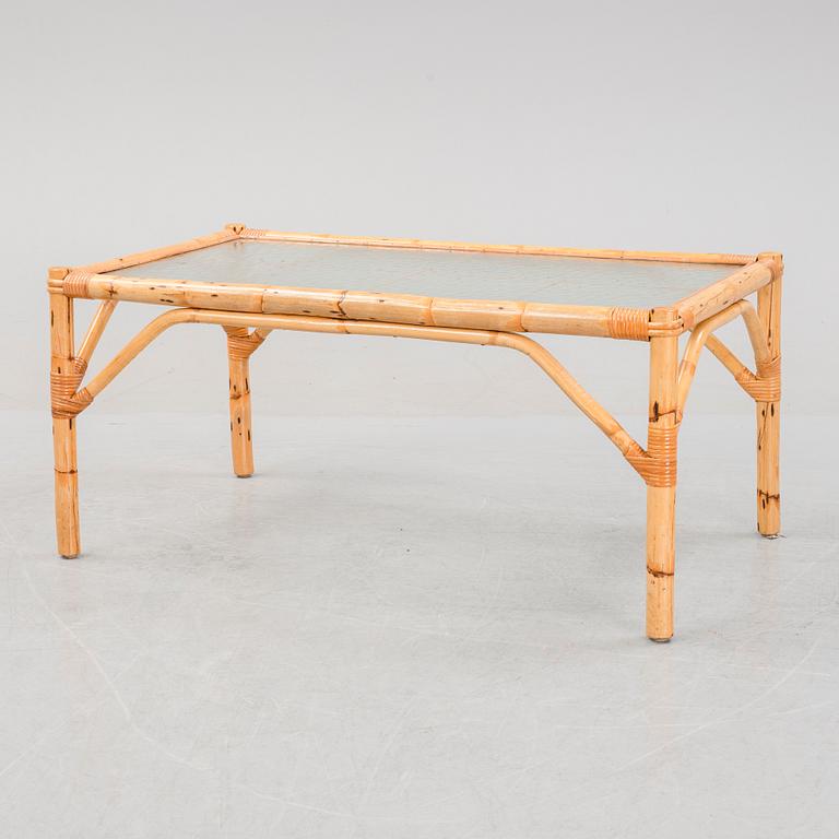 A set of two garden sofas, an armchair and a glass table, later part of the 20th Century.