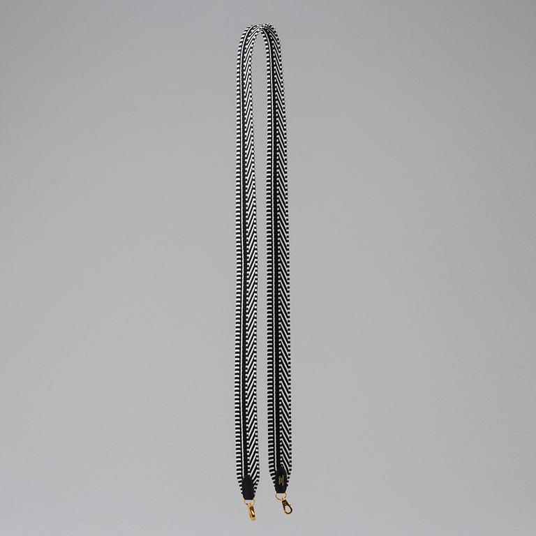 A bag strap by Hermès.