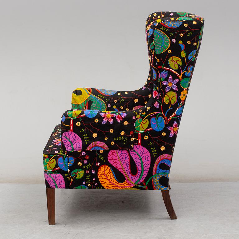 A 1960's/70's wing-chair with rosewwod legs.