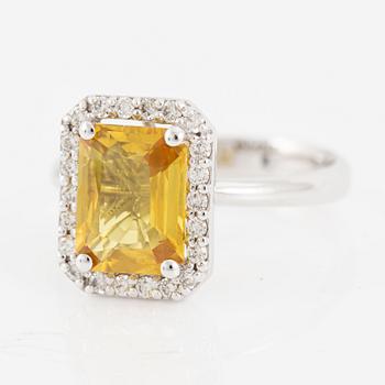 Ring in 18K gold with a faceted sapphire and round brilliant-cut diamonds.