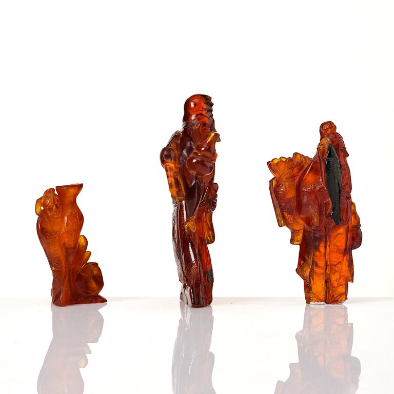 A group of three amber scultpures, late Qing dynasty/early 20th Century.