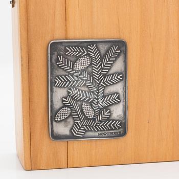 A set of six spruce cone motif coasters, Auran Kultaseppä, Turku 1968. In original wooden box.