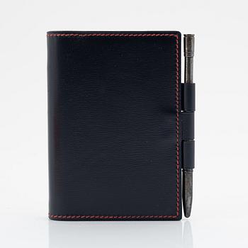 Hermès, a black leather notebook case & sterling silver pen.