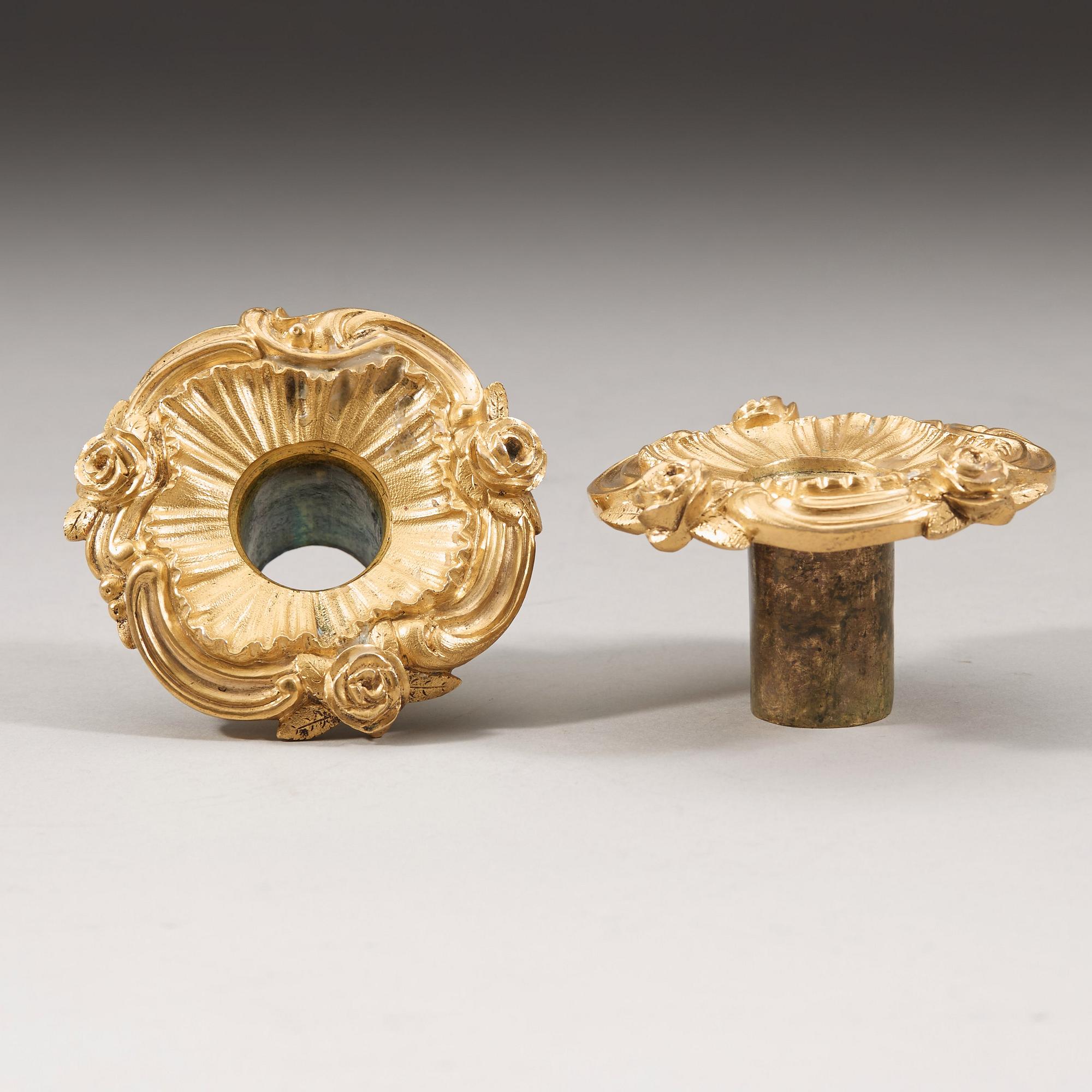 A pair of Louis XV 18th century gilt bronze candlesticks after the model by Juste-Aurèle Meissonnier.
