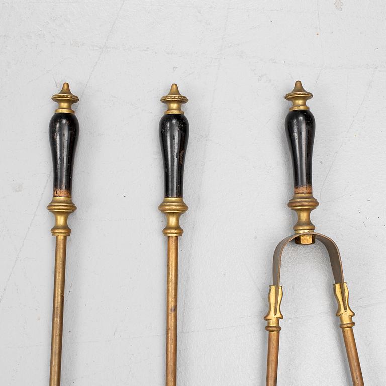 A set of three brass fire irons, 19th century.