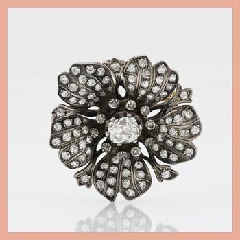 1126. A Victorian old- and rose-cut diamond brooch. Circa 1860. Center diamond circa 1.50 cts.