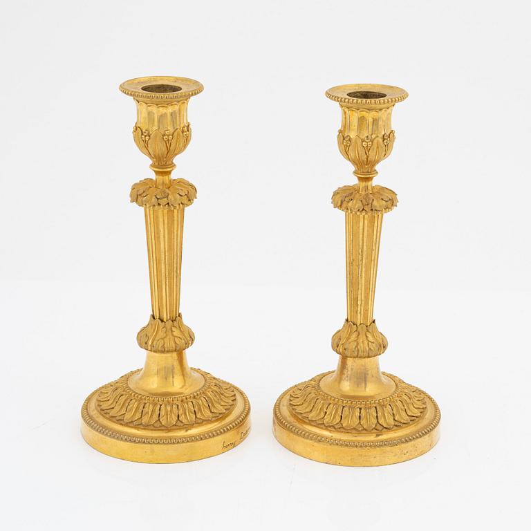 A pair of gilded bronze candelsticks, 19th Century.