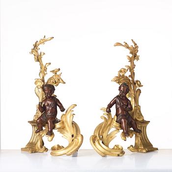 A pair of Louis XV-style 19th century fire dogs.