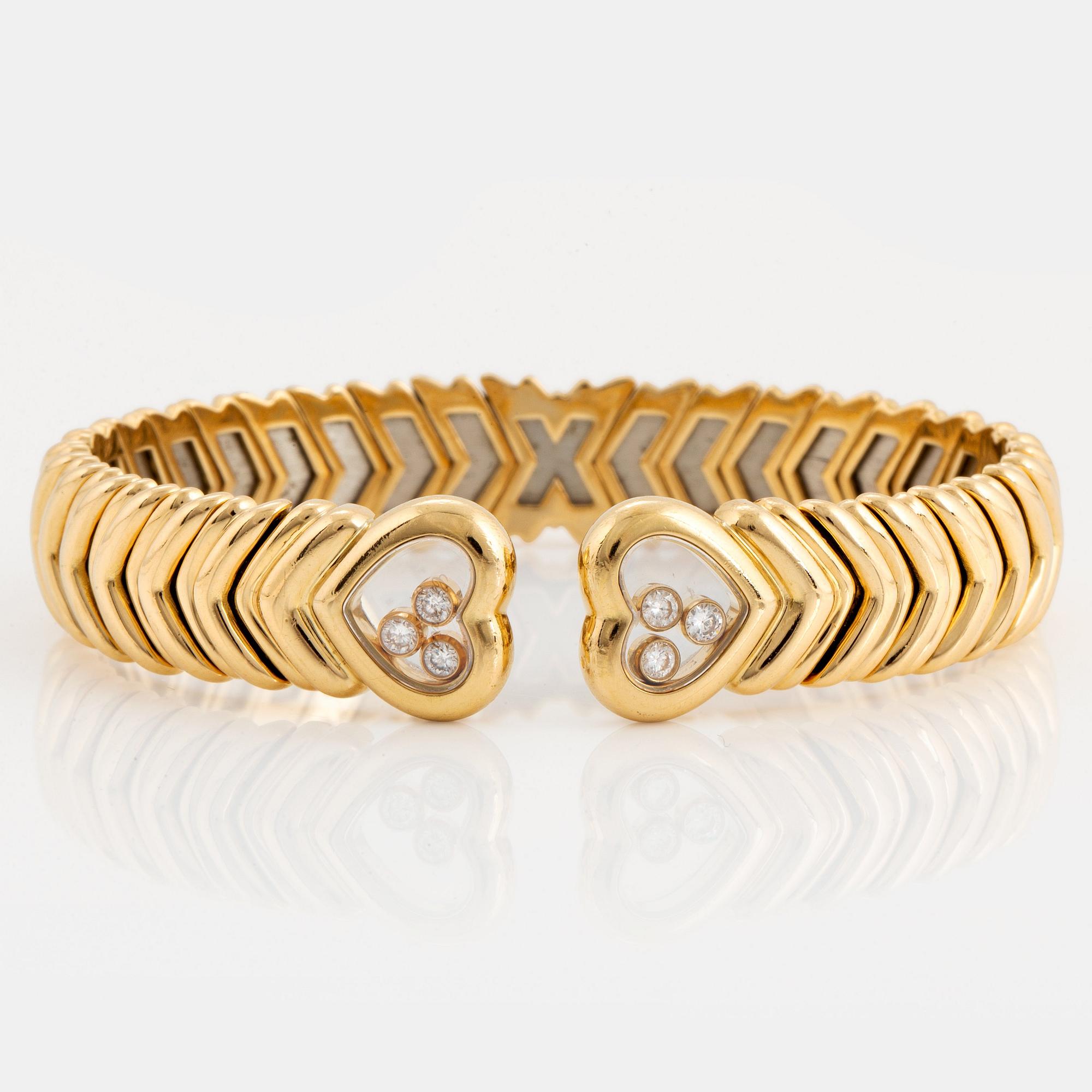 A Chopard "Happy Diamond" bangle in 18K gold.