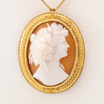 A Pendant/Brooch of carved shell cameo set in 14K gold and chain of low-grade gold.