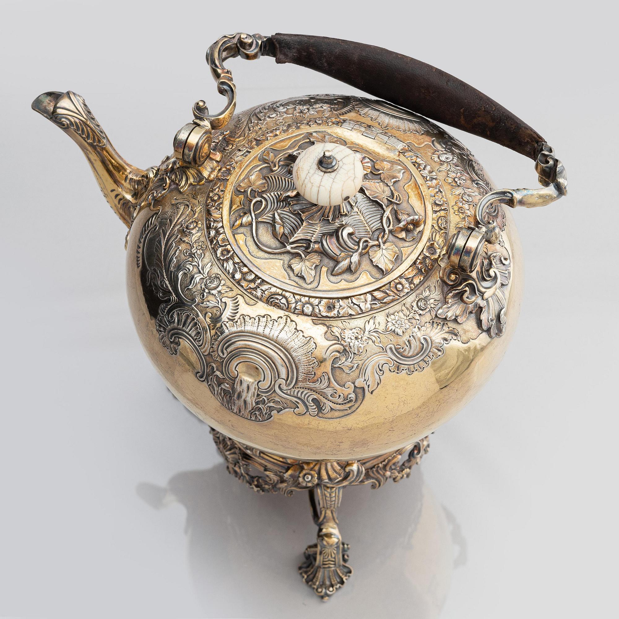 An English silver-gilt teapot with stand and burner, mark of Richard Sibley I, London 1825.