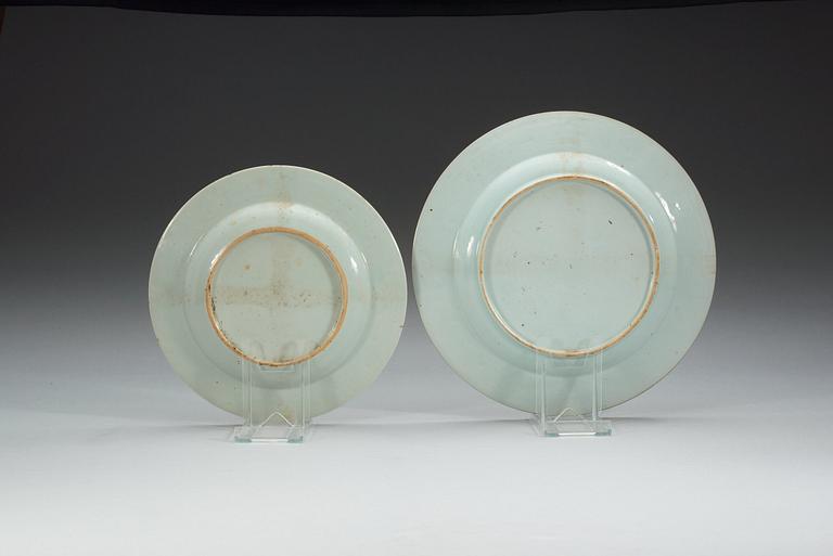 A set of four famille rose armorial dinner plates and a serving dish, Qing dynasty, Qianlong (1736-95).