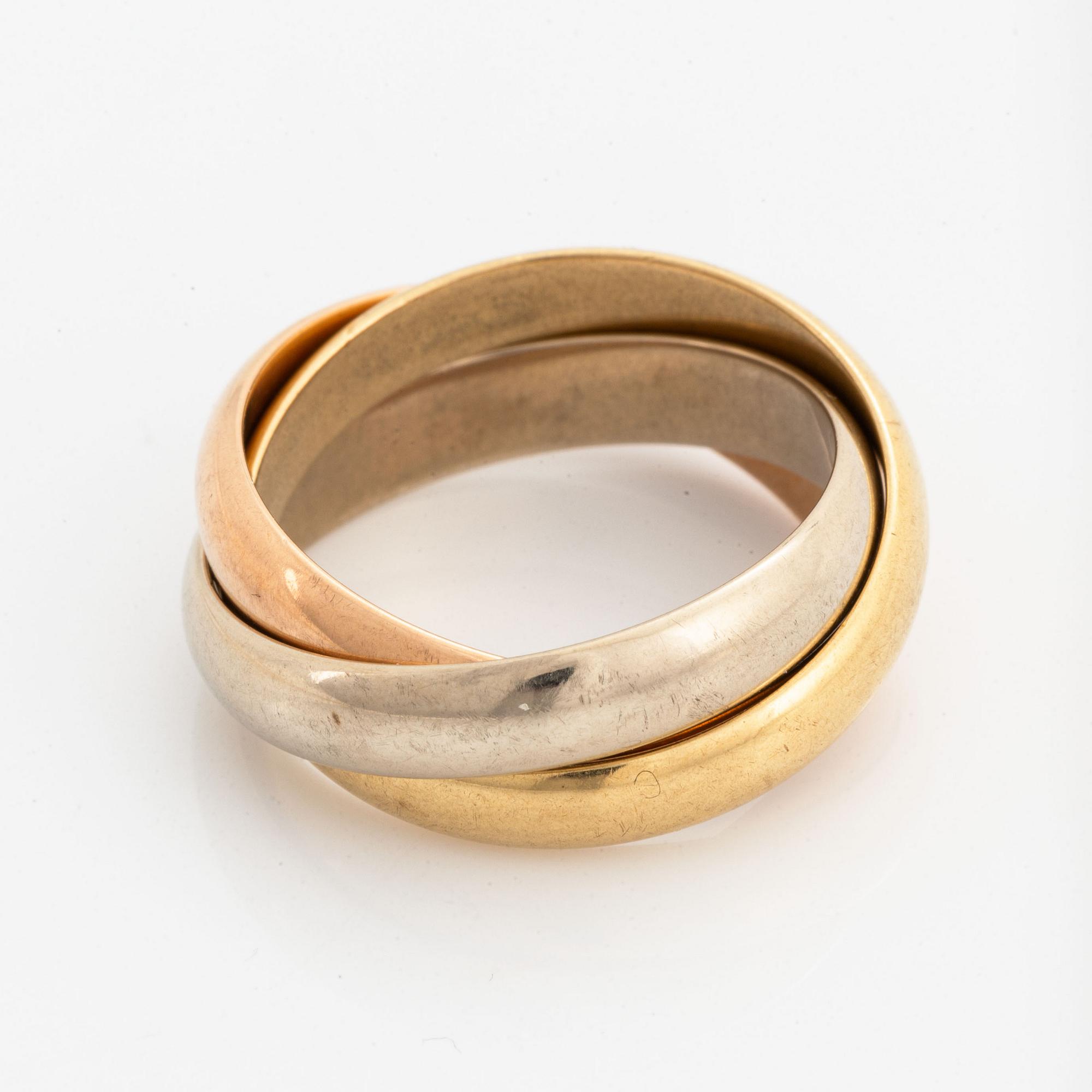 An 18K white, rose and yellow gold ring.