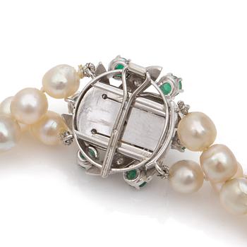 A double strand cultured pearl necklace Clasp set with diamonds and emeralds.