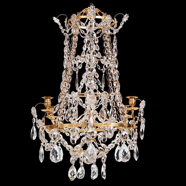 A Gustavian gilt-brass and cut-glass four-branch chandelier by O. Westerberg (master in Stockholm 1769-1881), dated 1795.